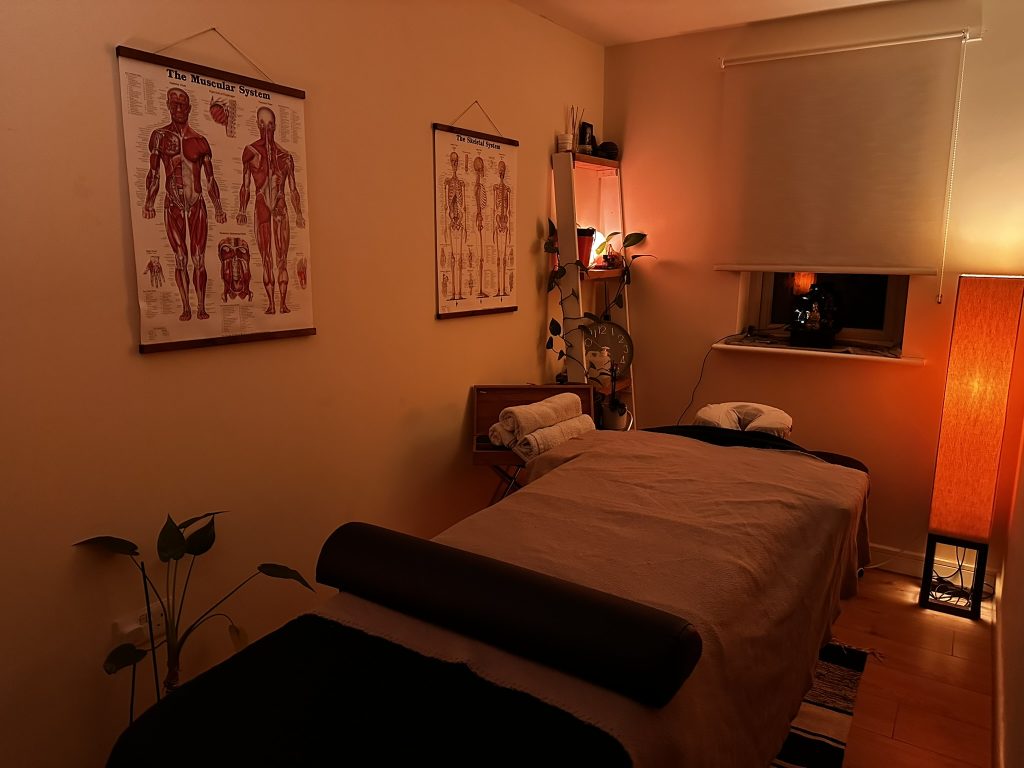 Reiki energy healing room with mood lighting and massage bed